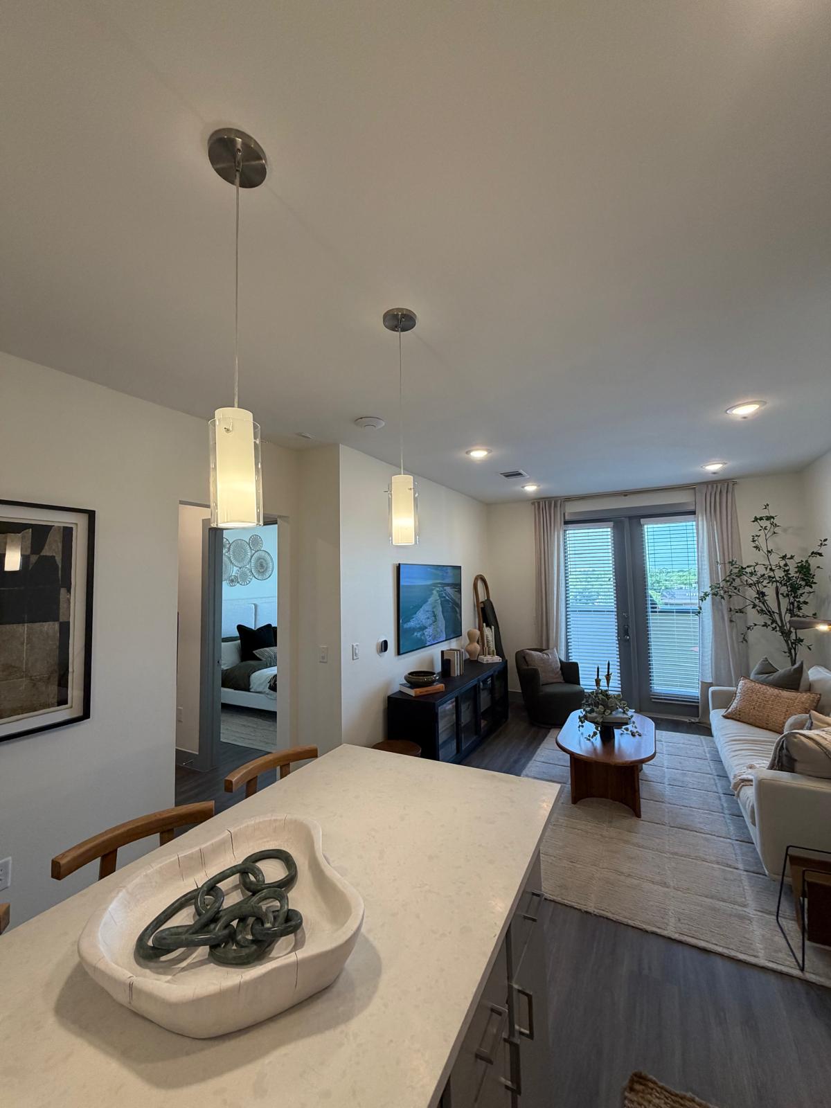 Open living and dining area of a unit, with the WiFi access point mounted centrally in the ceiling