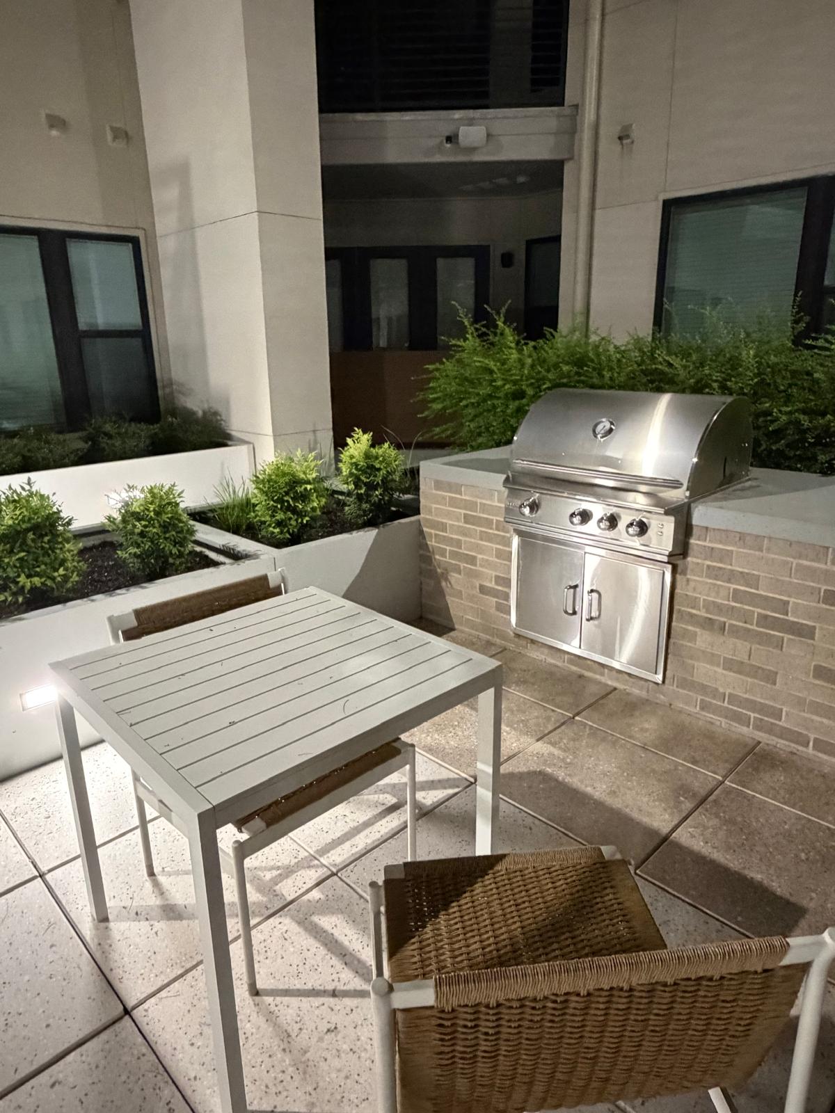 The outdoor grilling station and dining area in the courtyard