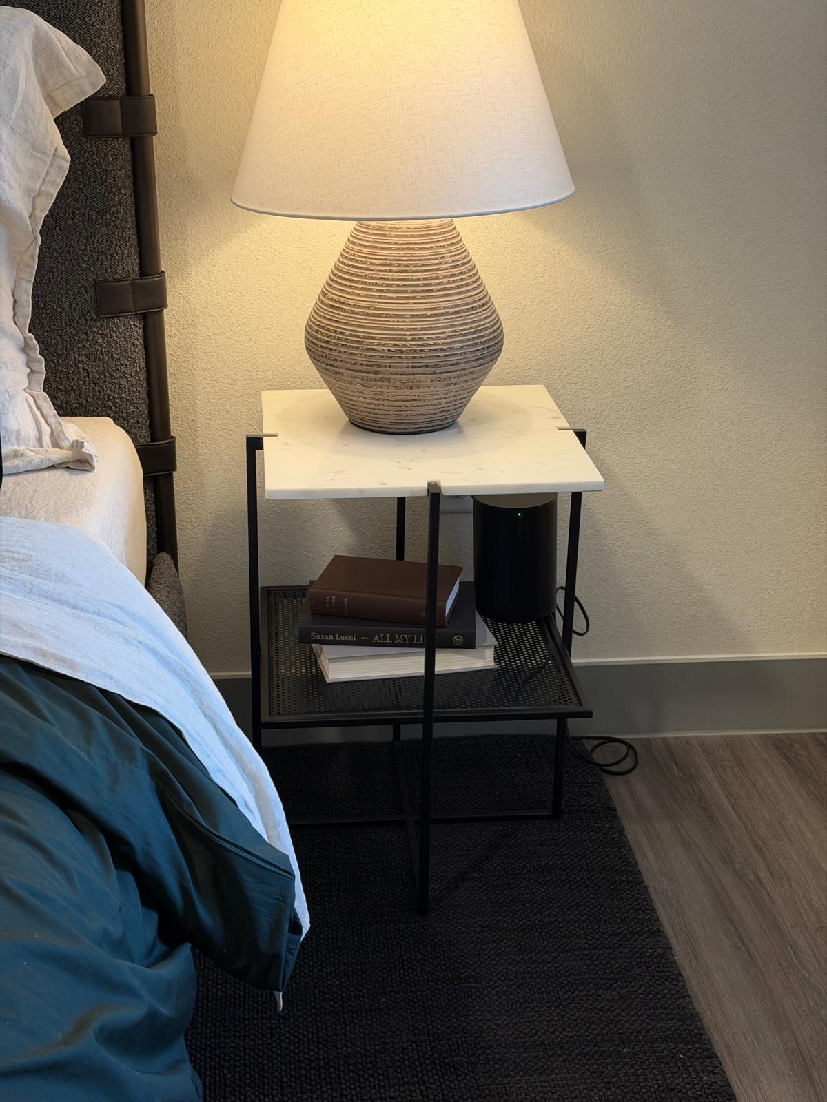 A Sonos speaker on a bedroom nightstand